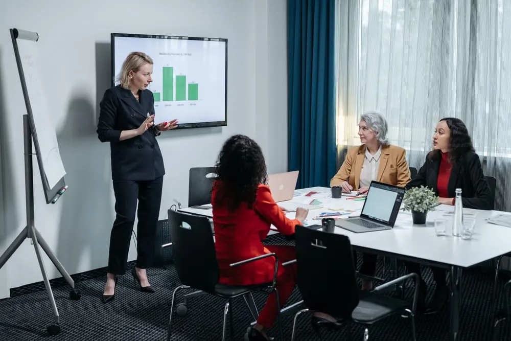 Colleagues discussing a deal in a meeting