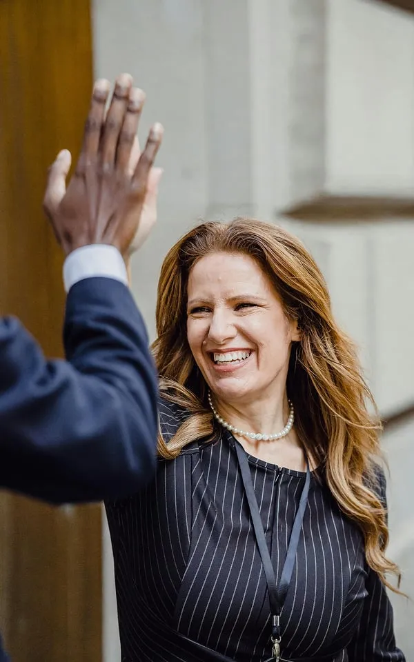 Two colleagues high-fiving in the office
